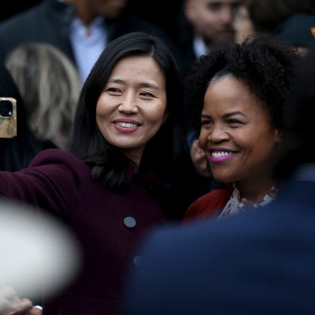 Boston Mayor Michelle Wu takes a selfie with former city mayor Kim Janey after the unveiling ceremony of "The Embrace," a sculpture dedicated to Rev. Martin Luther King Jr. and Coretta Scott King on Boston Common, Friday, Jan. 13,  2023.