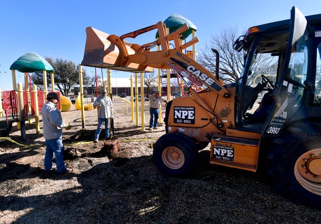 City crews remove cement anchors from a playground feature which caught fire Friday at Sears Park Jan. 13, 2023. The fire is still under investigation.