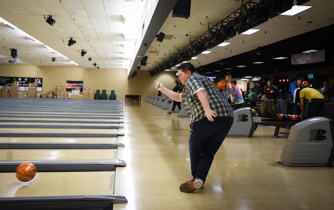 Mandy Malone-White of Lansing bowls Thursday, Jan. 12, 2023, during a GAAY Sports league bowling event at Spare Time Entertainment Center in Lansing. Malone-White and wife Dana moved to the Lansing area about a year ago from Denver and joined the league as a way to connect with others in the community.