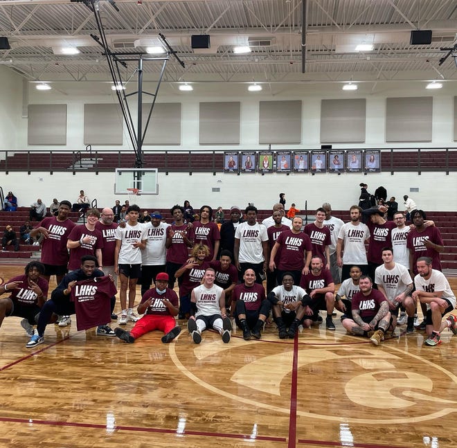 Members of the Maroon and White alumni teams pose for a photo after the game. The Maroon team won his first Licking Heights Boys Basketball Alumni Game on December 27, 2022.