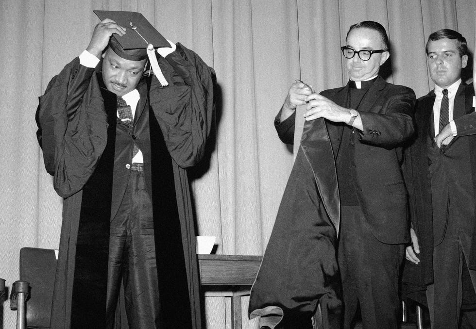 Dr. Martin Luther King is presented with the honorary degree of Doctor of Laws and Letters by Rev. Victor R. Yanitelli, president of Saint Peter's College at the school's Michaelmas Convocation in Jersey City, New Jersey, Sept. 22, 1965. Dr. King also delivered the convocation address at the ceremony.