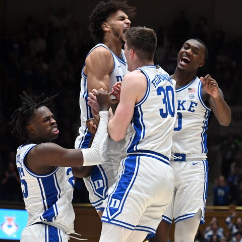 Duke players react to a basket during the second h