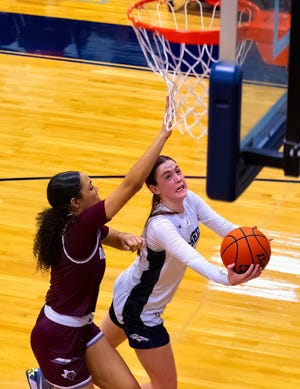 Riley Samples of McNeil's team rides down the lane from the layup as Danaë Jones defends in the fourth quarter.  Samples led the Mavericks with 20 points, 10 rebounds and four steals.