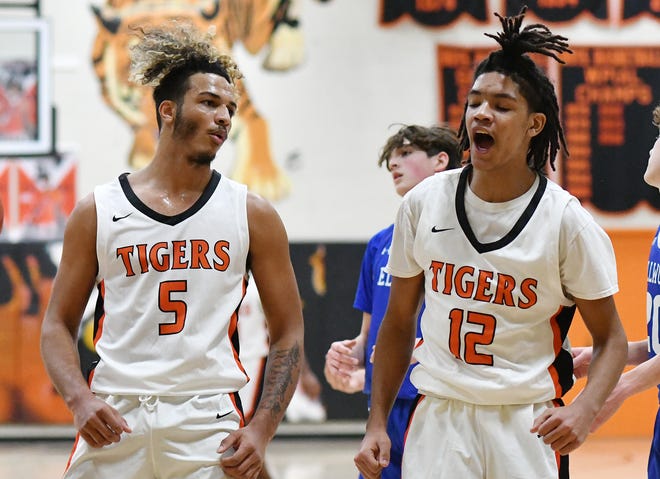 Beaver Falls' Isaiah Aeschbacher (5) and Jaydin Price (12) react after Price was fouled while scoring during Friday night's game against Ellwood at Beaver Falls High School.