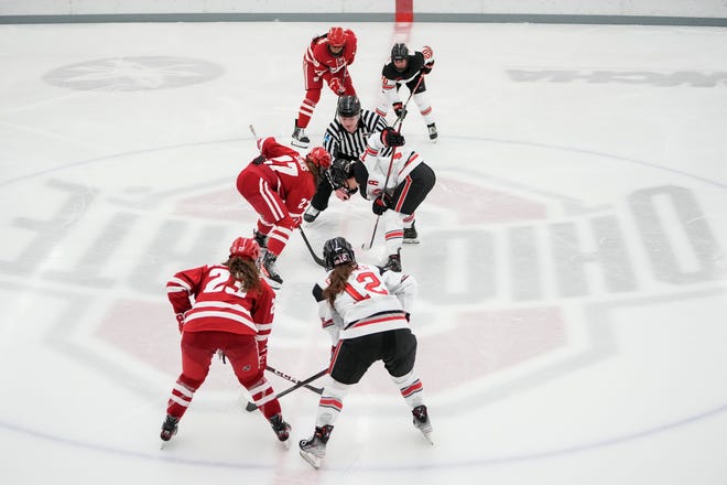 Jan 13, 2023; Columbus, Ohio, USA;  Ohio State Buckeyes forward Gabby Rosenthal (15) takes a faceoff against Wisconsin Badgers forward Kirsten Simms (27) during the NCAA women's hockey game at the OSU Ice Rink. Ohio State won 2-1 in overtime. Mandatory Credit: Adam Cairns-The Columbus Dispatch
