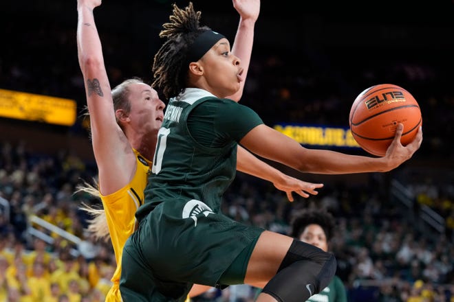 Michigan State guard DeeDee Hagemann (0), attempts a layup as Michigan guard Leigha Brown defends during the first half of an NCAA college basketball game, Saturday, Jan. 14, 2023, in Ann Arbor, Mich. (AP Photo/Carlos Osorio)