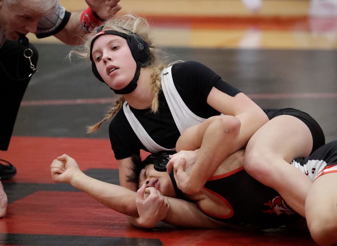 Plymouth’s Megan Schuenemann, top, controls Manitowoc Lincoln’s Nathan Yang during a 106-pound match Saturday at the Valders Wrestling Invitational in Valders. Schuenemann won the matchup.