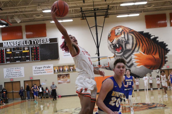 Mansfield Senior's Nathaniel Haney soars in the air for a layup in transition during the Tygers' 76-50 win over Wooster.
