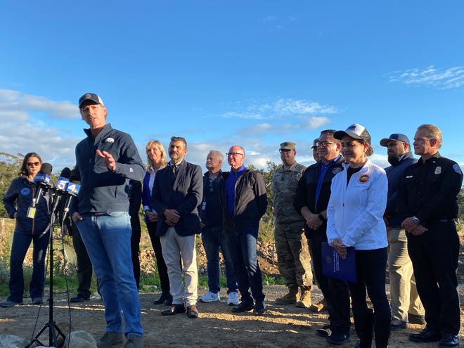 Gov. Gavin Newsom appears with area officials in Montecito Friday after storms caused damage around California and more rain was on the way.