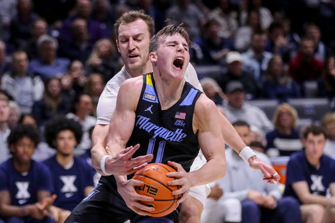 Marquette guard Tyler Kulick leads the basket against Xavier forward Jack Nung in the first half on Sunday.