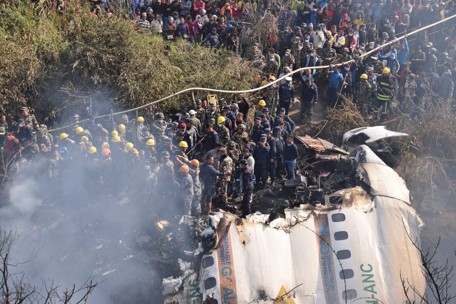January 15, 2023 : Nepalese rescue workers and civilians gather around the wreckage of a passenger plane that crashed in Pokhara, Nepal. Authorities in Nepal said 68 people have been confirmed dead after a regional passenger plane with 72 aboard crashed into a gorge while landing at a newly opened airport in the resort town of Pokhara. It's the country's deadliest airplane accident in three decades.