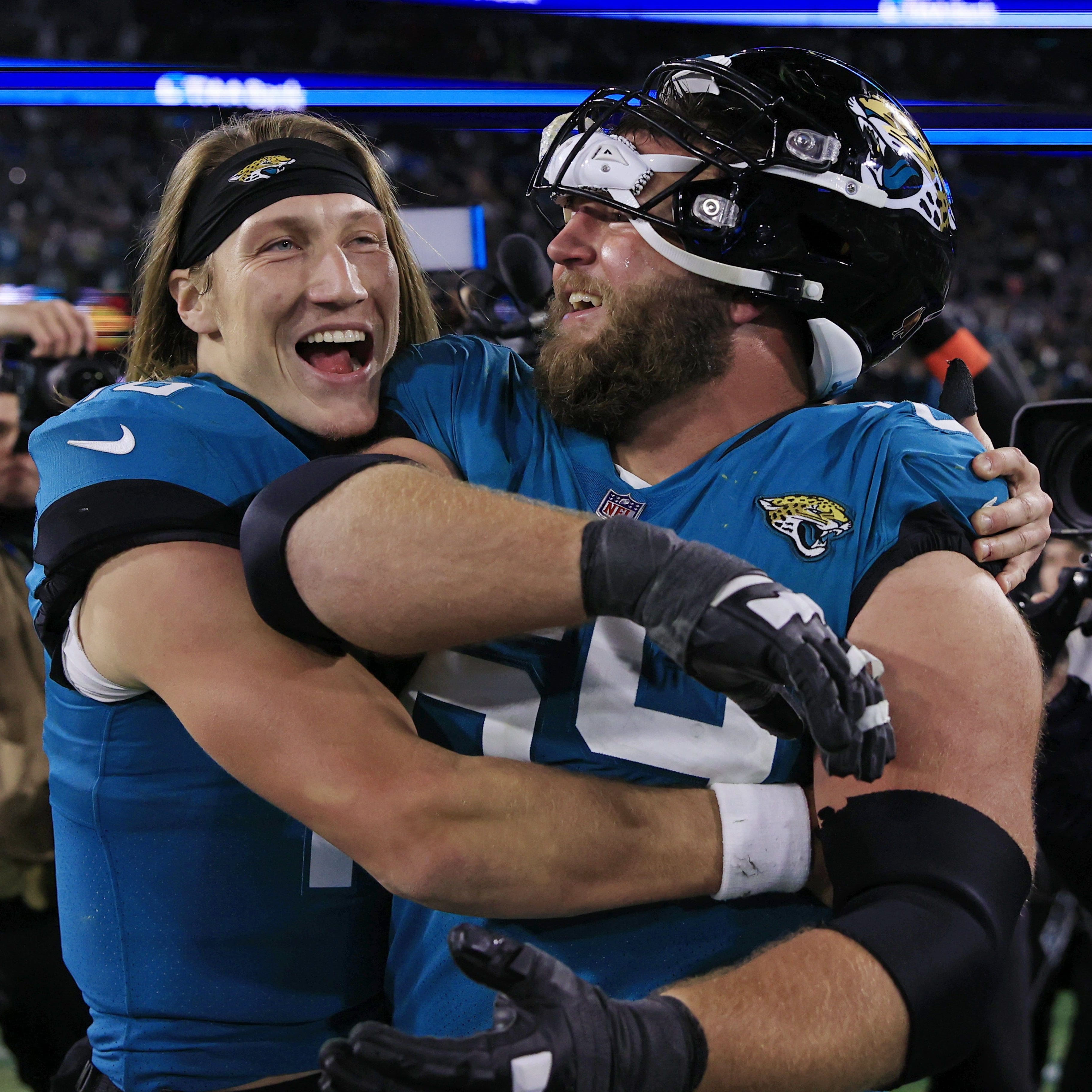 Jacksonville Jaguars quarterback Trevor Lawrence, left, hugs center Tyler Shatley after the win over the Los Angeles Chargers.