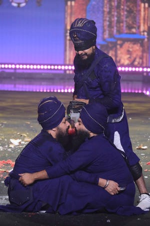 전기톱을 들고 있는 Pir Khalsa의 한 멤버와 두 명의 매우 자신감 있는 협력자.