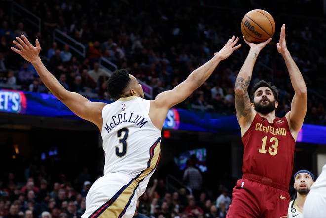 Cleveland Cavaliers guard Ricky Rubio (13) shoots against New Orleans Pelicans guard CJ McCollum (3) during the second half of an NBA basketball game, Monday, Jan. 16, 2023, in Cleveland. (AP Photo/Ron Schwane)