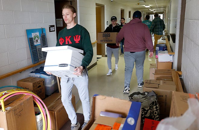 Ashland University students and members of Phi Kappa Psi fraternity junior Ethan Wolford and freshman Jake Bucher carry boxes out of the Ashland Parenting Plus offices in the Ashland County Service Center and help move them to the agency's new office on Sandusky Street as a part of AU GIVS (Ashland University Gets Involved with Volunteer Service) Martin Luther King Jr. Day service projects on Monday.
