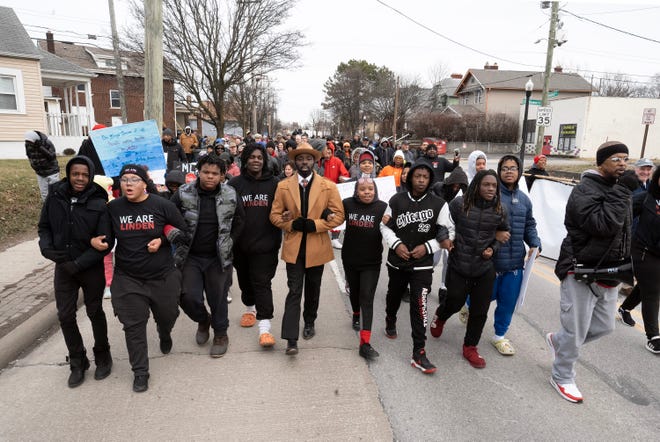 Jan 16, 2023; Columbus, Ohio, USA; March co-organizer Londale Towns links arms with other participants at the end of the We Are Linden Annual MLK March. Mandatory Credit: Brooke LaValley/Columbus Dispatch