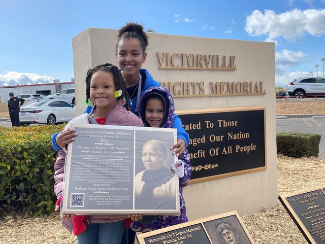 Student Natalia Jackson, center, the winner of the City of Victorville’s Annual Civil Rights Memorial Essay Contest, holds her plaque that highlights activist Frances Ellen Watkins Harper with sister, Oryin Jackson, right, and friend, Aneliese Brown, at the 15th Annual Dr. Martin Luther King, Jr. Commemorative Peace March & Ceremony in Victorville.
