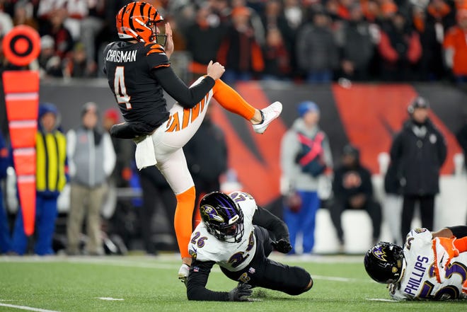Cincinnati Bengals punter Drue Chrisman (4) draws a from Baltimore Ravens safety Geno Stone (26) in the fourth quarter during an NFL wild-card playoff football game between the Baltimore Ravens and the Cincinnati Bengals, Sunday, Jan. 15, 2023, at Paycor Stadium in Cincinnati. The Cincinnati Bengals won, 24-17. The Cincinnati Bengals advance with the win to play the Buffalo Bills in the divisional round. 