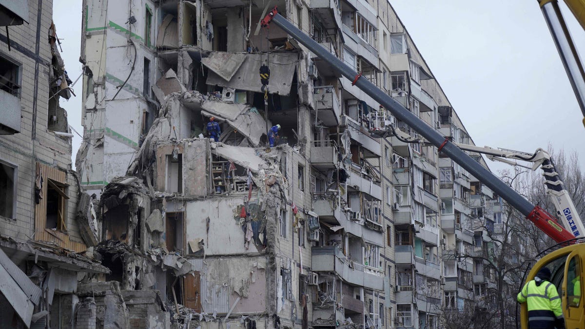Rescuers work on a residential building destroyed after a missile strike, in Dnipro on January 16, 2023.AFP_33777EQ.jpg