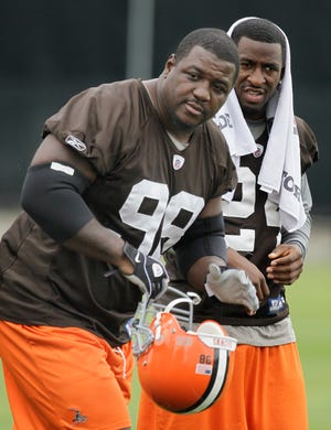Browns defensive end Robaire Smith (98) and cornerback Eric Wright are seen on the field during the team's minicamp in Berea on Friday, June 11, 2010.