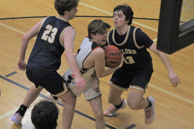 Cheboygan junior guard Daniel Hudson (middle) looks to get past Gaylord defenders Luke Enders (23) and Will Bethuy (13) during the first half of Monday's boys basketball matchup at Cheboygan.