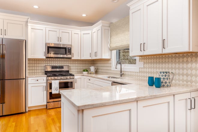 This kitchen features white, shaker-style cabinetry.
