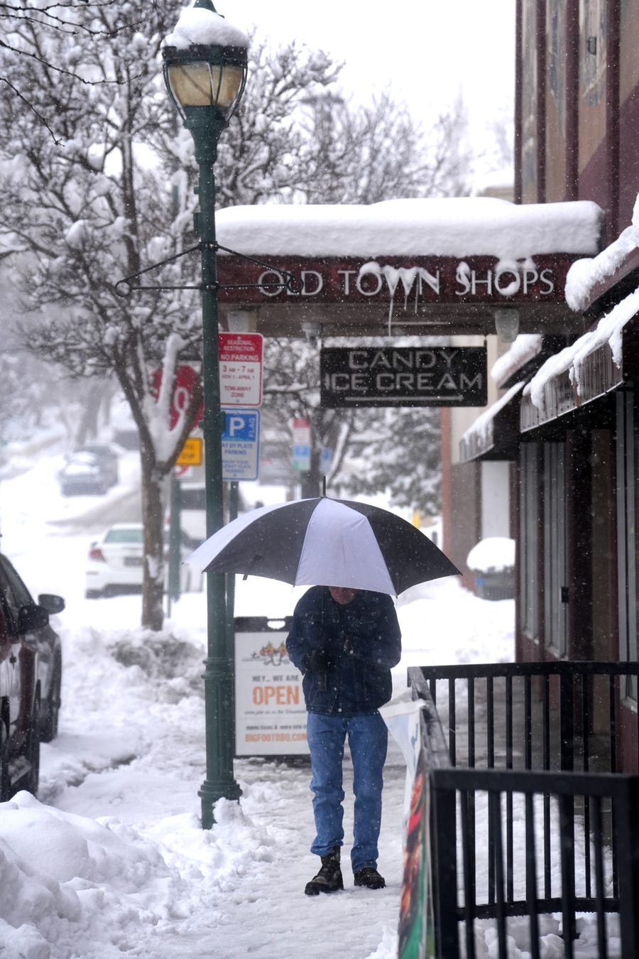 People walk through heavy snow fall in Downtown Flagstaff on Monday, Jan. 16, 2023. 
