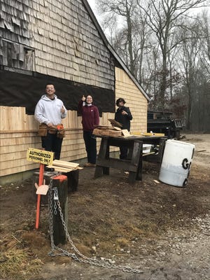 Students from Diman's building and property maintenance program are working on improvements to the Beech Grove Cemetery in Westport, including re-roofing one side of the maintenance shed.