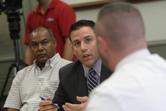 During a 2014 Providence Licensing Commission hearing, attorney John Choli (middle) representing the bar questions Providence police officers.
