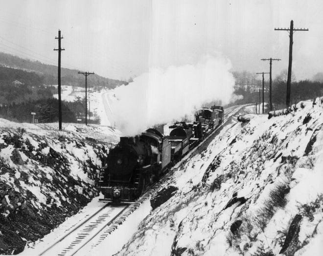 This 1948 photograph, taken from the Buckeye Cove Bridge, shows a train barreling through the snow in Buckeye Cove.