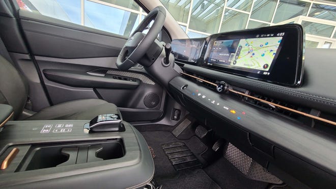 The stylish console of the 2023 Nissan Ariya with cube-sized shifter and haptic button controls.