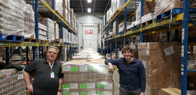 The 35,000-pound shipment of pork was received by Wisconsin Farmers Union Rural Organizer Hayden Cohan, right, and Second Harvest Foodbank Director of Marketing & Communications Kristopher Tazelaar.