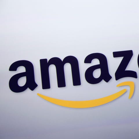 The Amazon logo is displayed at a news conference 