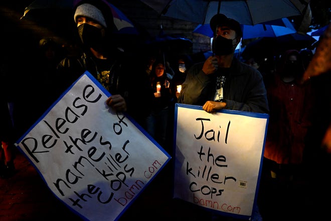 People hold signs demanding the release of the names of the LAPD officers involved and their imprisonment during a vigil in Los Angeles on Saturday, January 14, 2023 for Keenan Anderson, the cousin of Black Lives Matters co-founder Patrisse Cullors, who has went into cardiac arrest and died on January 3 after Los Angeles police tasered him following a traffic accident.  (Photo by Keith Birmingham/The Orange County Register via AP) XMIT ORG: CAVAN606