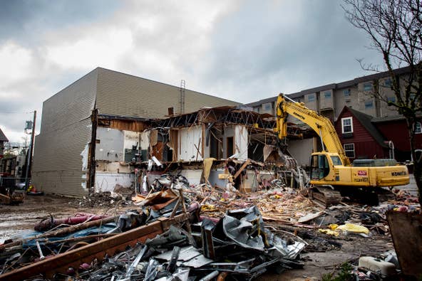 An excavator tears down the former Smith Family Bookstore on East 13th Avenue in Eugene Thursday, Jan. 19, 2023.