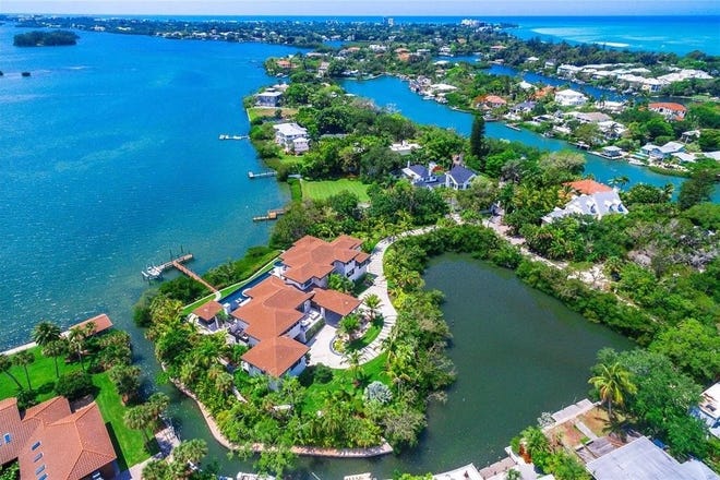 This waterfront estate on Siesta Key that is surrounded by water has been listed for sale for $22 million, taking the top spot for most expensive residential property in the region.