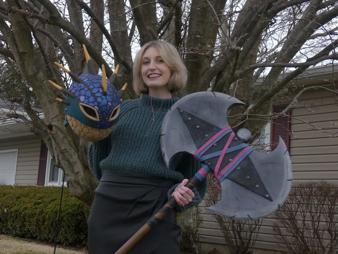 Cosplayer Allison Lutz holds part of her handmade Astrid costume from How To Train Your Dragon.