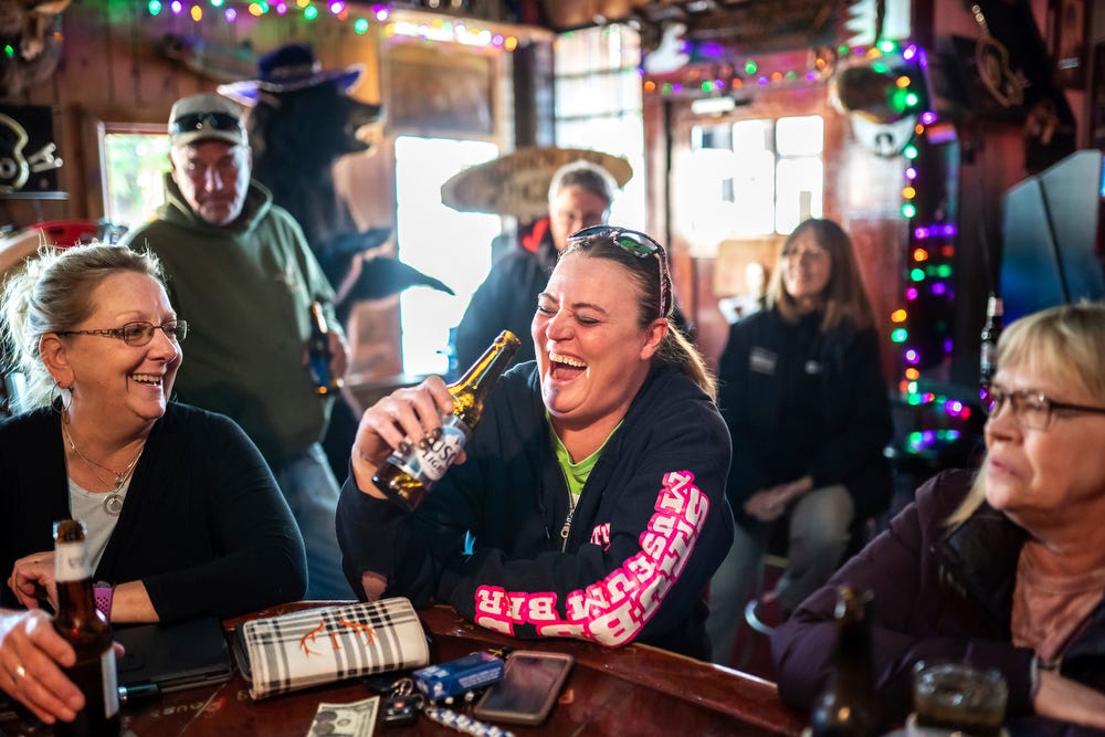 Stubb's Museum Bar bartender Jen Butler, center, 41, of Ontonagon, shares a laugh and a drink on her day off with friends Lisa McGuire, 55, left, of Ontonagon, and Kathy Schober, right, 62, of Ontonagon, on Wednesday, Oct. 19, 2022.