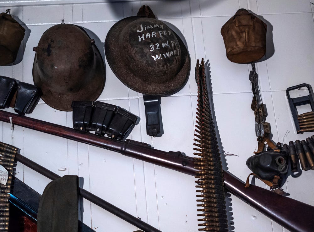 Military items, donated by veterans in town, hang on the wall at Stubb's Museum Bar in Ontonagon on Wednesday, Oct. 19, 2022.