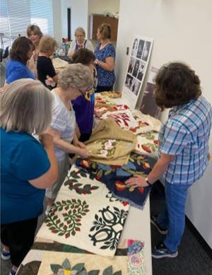 Members of the Hills Quilting Ladies admiring the intricate design work of Bowie artist, Verna Mae Brashear.