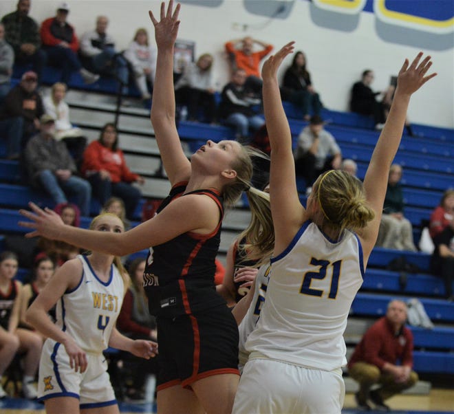 Liberty Union's Abbie Riddle puts a shot up over West Muskingum's Zoie Settles in Wednesday's game. The Lions won 47-44, as Riddle surpassed 1,000 career points.