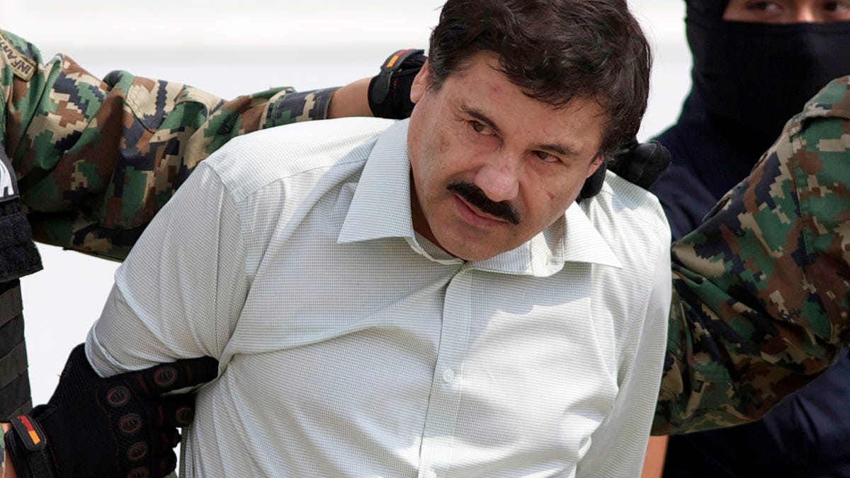 Joaquin "El Chapo" Guzman, the head of Mexico's Sinaloa Cartel, is escorted to a helicopter in Mexico City following his capture in the beach resort town of Mazatlan, Mexico.