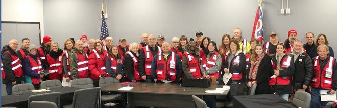 Representatives of the American Red Cross and local volunteers met at the new Newcomerstown Administration Building prior to going out to distribute free smoke alarms to an area of the village. Mayor Pat Cadle is pictured at the far left.