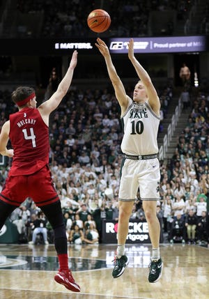 Michigan State forward Joey Hauser scores past Rutgers goaltender Paul Mulcahy during halftime on Thursday, January 19, 2023 at the Breslin Center.