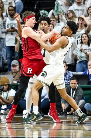 Michigan State's Jaden Akins, right, steals the ball from Rutgers' Paul Mulcahy after pressure from A.J. Hoggard, center, during the second half on Thursday, Jan. 19, 2023, at the Breslin Center in East Lansing.