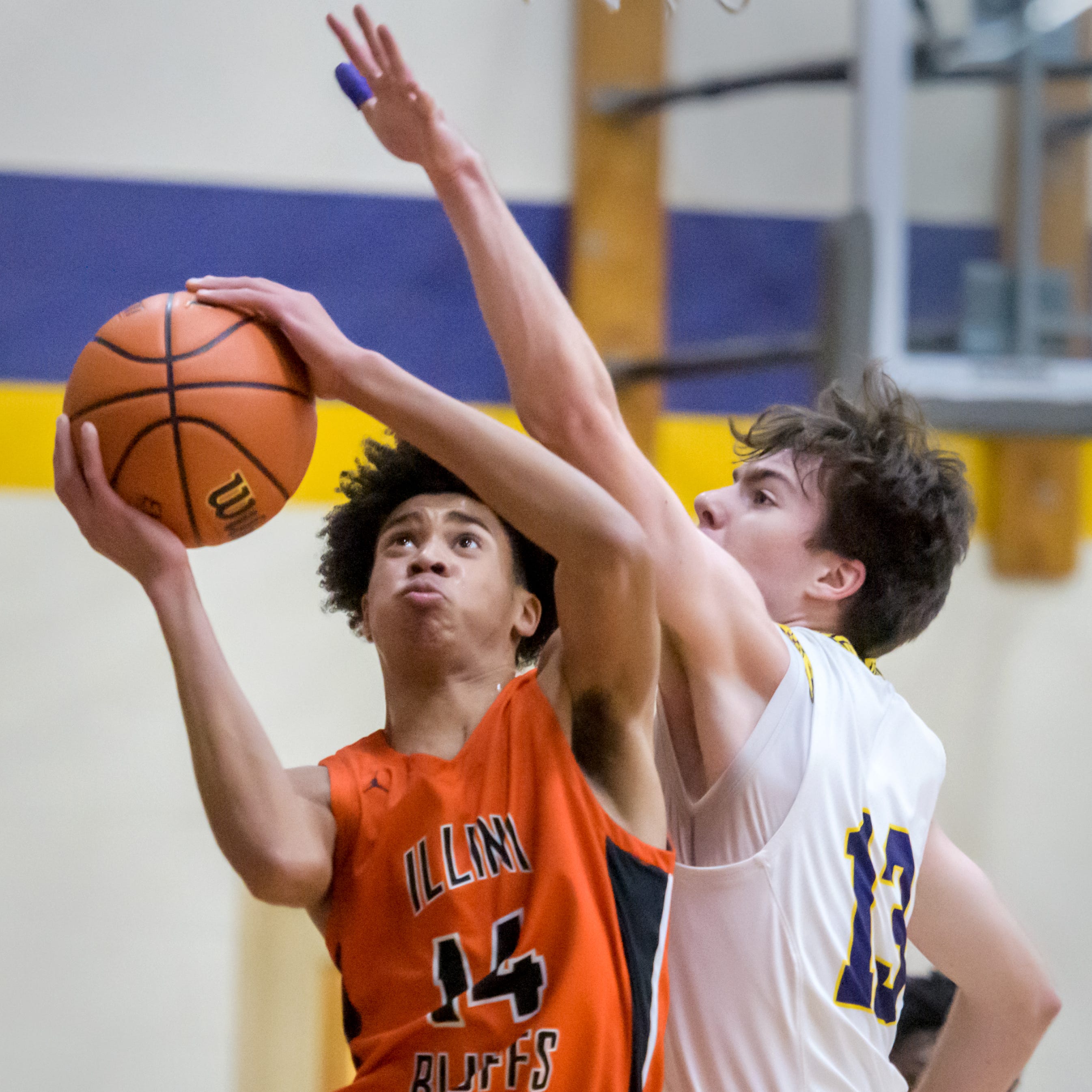 Illini Bluffs' Devon White (14) moves to the basket against Peoria Christian's Jayce Moody in the first half Friday, Jan. 20, 2023 at Peoria Christian High School. The Tigers defeated the Crusaders 45-35.