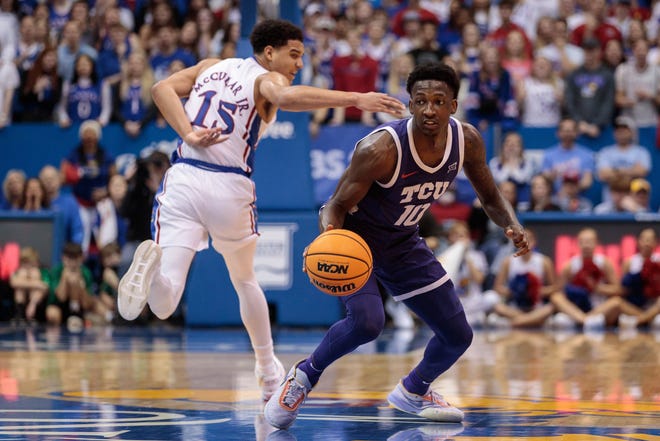 Jan 21, 2023; Lawrence, Kansas, USA; Kansas Jayhawks guard Kevin McCullar Jr. (15) misses a steal from TCU Horned Frogs guard Damion Baugh (10) during the first half at Allen Fieldhouse. Mandatory Credit: William Purnell-USA TODAY Sports