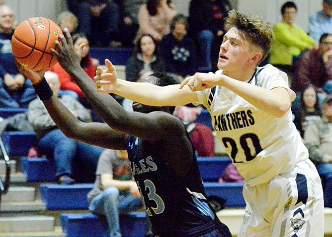 Great Plains Lutheran's Jacob Bartels (20) battles for a rebound against Sioux Falls Lutheran's Muoch Jud during their high school boys basketball game on Friday, Jan. 20, 2023 in Watertown.