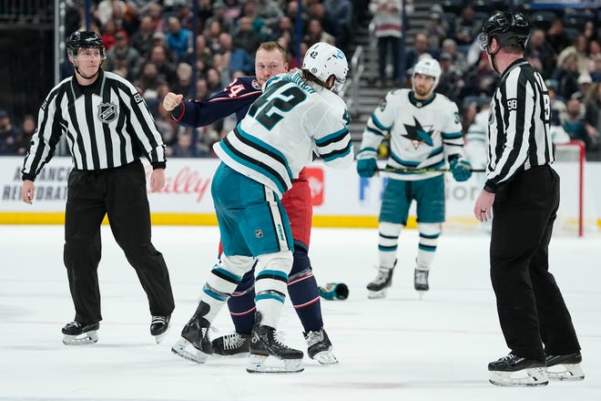 Jan 21, 2023; Columbus, Ohio, USA;  Columbus Blue Jackets right wing Mathieu Olivier (24) fights San Jose Sharks left wing Jonah Gadjovich (42) during the second period of the NHL hockey game at Nationwide Arena. Mandatory Credit: Adam Cairns-The Columbus Dispatch