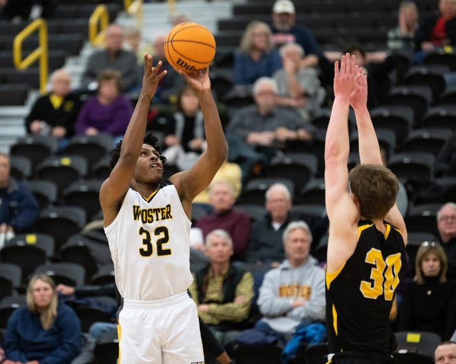 The College of Wooster's Elijah Meredith shoots over a defender in a 80-73 win over DePauw.